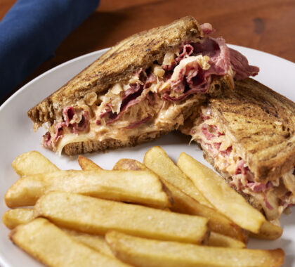 A reuben sandwich with fries