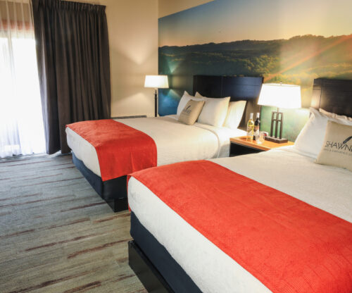 Queen room with neatly made beds at Shawnee State Park Lodge